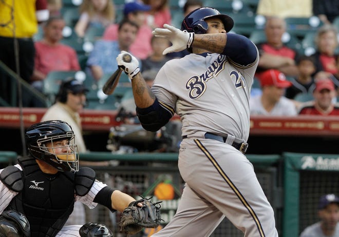 Milwaukee Brewers' Prince Fielder (28) and Houston Astros catcher Humberto Quintero, left, watch as Fielder's hit heads out over the wall for a solo home run in the first inning of a baseball game on Friday, April 29, 2011, in Houston.