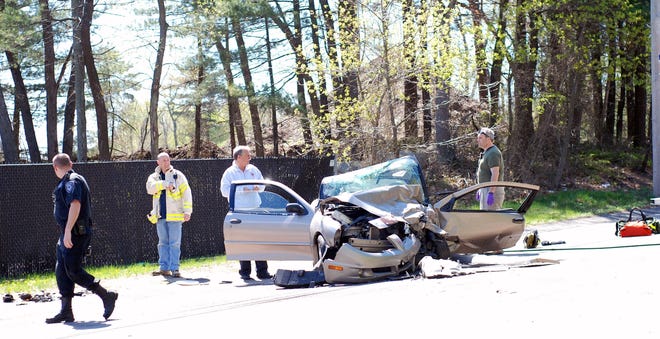 Four people were injured in a head-on crash Sunday, May 1, 2011, on Route 18 in Abington. Pictured left to right are Plymouth County Bureau of Criminal Investigation officer Sean Chrisman, Abington Fire Chief John Nuttall, Abington fire Capt. David Farrell and firefighter Richard Smith.