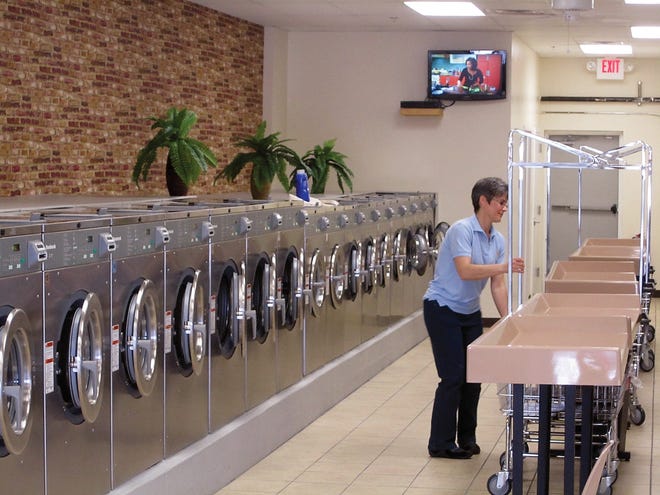 Photo by Steven Reilly/New Jersey Herald 
Owner Faith VanAlthuis, of Wantage, gets ready for customers at the new Laundry Station in Port Jervis, N.Y.