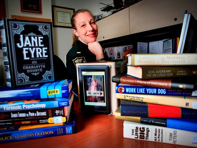 Lt. Bella Blizzard of the Alachua County Sheriff's Office, shown with her Nook e-reader, is an avid and dedicated reader. She is shown on April 22 at the Sheriff's Office in Gainesville.