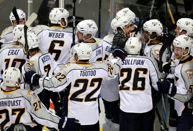 Members of the Nashville Predators celebrate Matt Halischuk's game winning goal against the Vancouver Canucks during the second overtime period of game 2 of an NHL Western Conference semifinal Stanley Cup playoff hockey series in Vancouver, B.C., on Saturday April 30, 2011. (AP Photo/The Canadian Press, Jonathan Hayward)