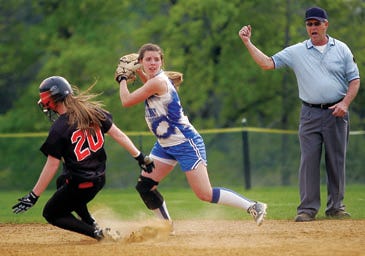 Photo by Daniel Freel/New Jersey Herald 
 
 The umpire, right, calls Hackettstown’s Faith Ely, left, out at second base as Kittatinny’s Sarah Brook looks to make a double play Monday in Hackettstown. The Cougars won, 9-1.