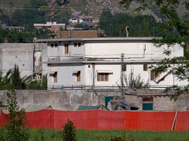 A Pakistan army soldier stands on top of the house where it is believed al-Qaida leader Osama bin Laden lived in Abbottabad, Pakistan on Monday, May 2, 2011. Bin Laden, the mastermind behind the Sept. 11, 2001, terror attacks that killed thousands of people, was slain in his hideout in Pakistan early Monday in a firefight with U.S. forces, ending a manhunt that spanned a frustrating decade. (AP)