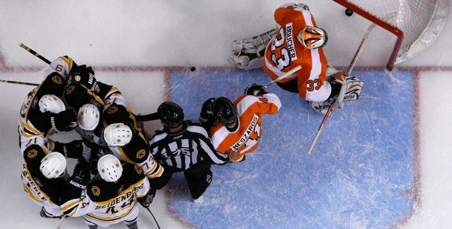 The Bruins celebrate after a goal by Chris Kelly against Flyers goalie Brian Boucher, right, in Game 2 of the Eastern Conference semifinal series. Game 3 is Wednesday night.