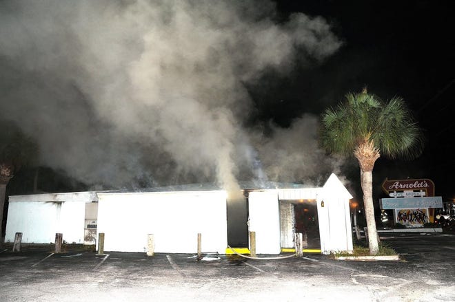 Arnold's Bar in St. Augustine belches smoke after a fire gutted it on Wednesday. The owner hopes to reopen as soon as possible.