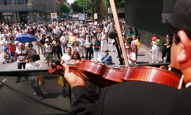 A crowd gathers on April 28, 1996 to listen to the Mariachi Jaliciense band at the “LA Fiesta Broadway” street party in Los Angeles. The party, commemorating Mexico's “Cinco de Mayo” military victory over the French in 1862, is considered the largest of its kind in the country. (The Associated Press)