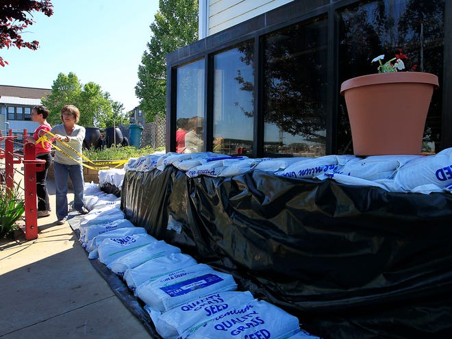 Head Mistress Maria Cole cordons off an area where sandbags are positioned to keep the rising Mississippi River from entering the Maria Montessori School on Mud Island in Memphis, Tenn., on Wednesday, May 4, 2011. The National Weather Service is predicting a 48-foot crest of the Mississippi River on May 11. (AP)