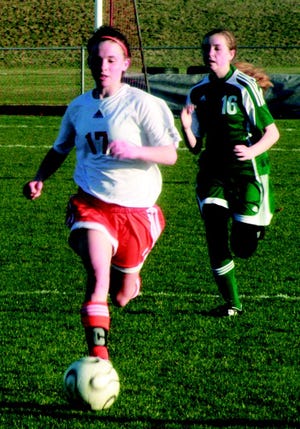 Cheboygan’s Beth Reynolds (17) dribbles the ball, while Grayling’s Meghan Beard looks to chase her down during the second half of their soccer match at Cheboygan on Wednesday.