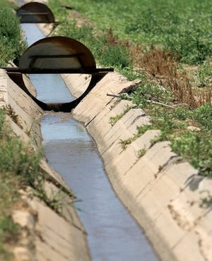 Water flows through a concrete-lined lateral on the Bessemer Ditch. Farmers are counting on the snowpack to make it through what has so far been a dry year.