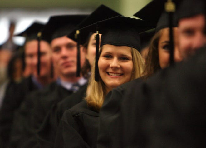 Graduates wait to go on stage to receive their degrees during the Stonehill College commencement exercises in 2009.