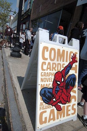 John Huff/Staff photographer 
Comic book fans gather outside Jetpack Comics in Rochester Saturday for the National Free Comic Book Day event.