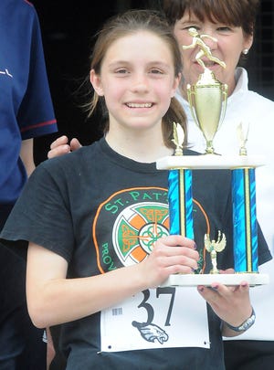 Rita Maurais, 13, of Hopedale, won the overall women's race with a time of 20:30 in the annual Hopedale 5K road race in honor of former running coach Larry Olsen. The race was held Saturday in Hopedale.