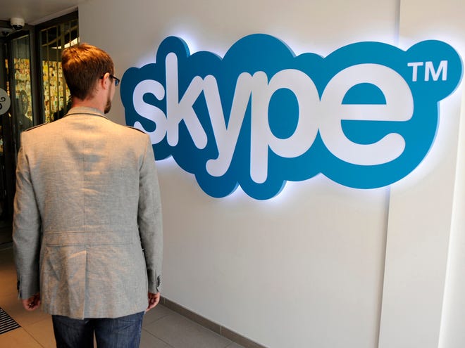 A man walks past the Skype logo at Skype company headquarters in Luxembourg, Tuesday, May 10, 2011. Microsoft Corp. said Tuesday that it has agreed to buy the popular Internet telephone service Skype SA for dlrs 8.5 billion U.S. in the biggest deal in the software maker's 36-year history. (AP Photo)