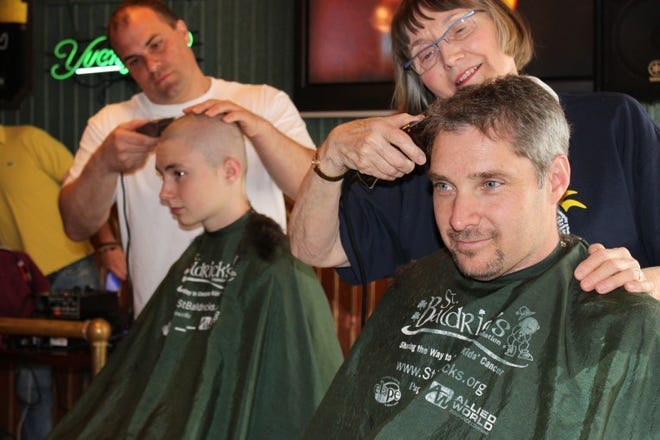 Matt Caffrey, the owner of Chambers 19 and The Other Side, gets his head shaved by Doylestown Mayor Libby White.
