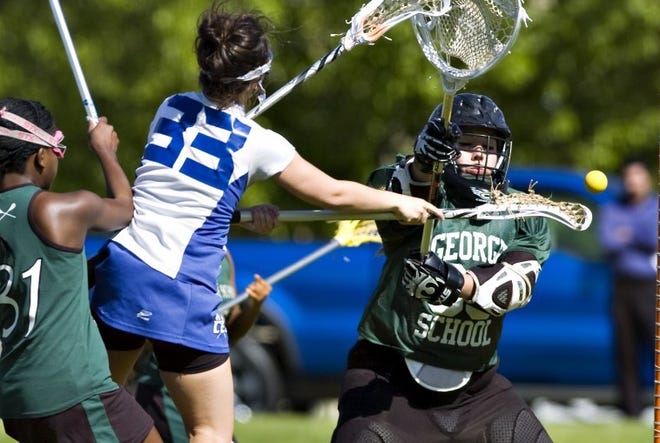 (left) Conwell Egan's Kate Jones scores on goalie Carly Rodgers in the first half. Conwell Egan beat George School 13-7 in girls lacrosse at home.