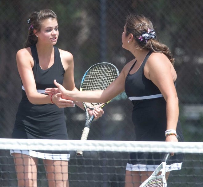 South High School's Kayleigh Brown (left) and Brittany Trevithick congratulate each other on a good point Saturday in the Region 7 finals at No. 1 doubles. They will be back at City Park today when the Class 4A girls state tennis tournament opens.