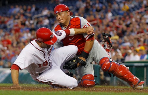FILE PHOTO - Washington Nationals base runner Danny Espinosa is out at home as he is tagged by Philadelphia Phillies catcher Carlos Ruiz during the third inning of a baseball game at Nationals Park on Thursday, April 14, 2011 in Washington.(AP Photo/Alex Brandon)