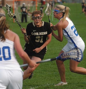 Corning's Neena Merola tries to cut past Horseheads defender Cassidy Tingley to get to the Horseheads goal.
