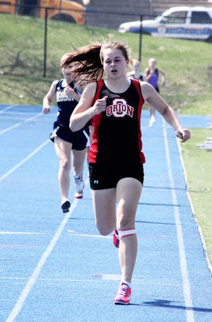 Ashley Anderson leads other competitors during the Davenport Assumption meet on Saturday, April 9, at Ericson Field, Augustana College, Rock Island.