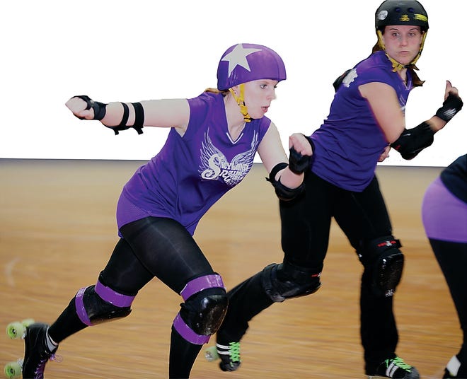 Photo by Sara Hudock-Cole/New Jersey Herald 
A jammer, left, attempts to score by passing the blockers at a recent Skyland Roller Girls Roller Derby scrimmage in Hackettstown. The group is in its third season.