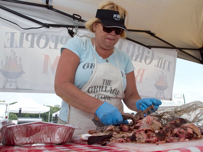 Becky Purtill of The Grillage People in Ocala prepares pulled pork during the Pig Out BBQ Bash on Saturday. See a photo gallery of the event at www.ocala.com