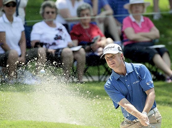 David Toms hits from the sand on the 15th hole during the second round of The Players Championship Friday in Ponte Vedra Beach. Toms finished with a one-shot lead. By CHRIS O'MEARA, The Associated Press