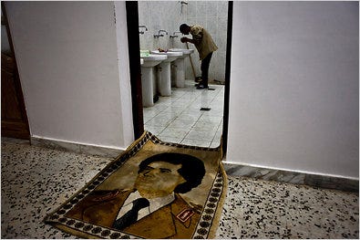 A tapestry of Col. Muammar el-Qaddafi serves as a washroom mat at a rebel prison in Libya.