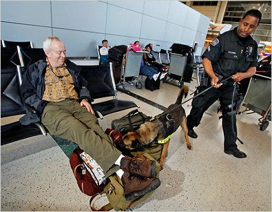 A police officer and a sniffer dog on Thursday at Los Angeles International Airport after a demonstraton of the dogs.
