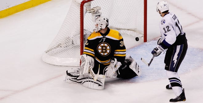 Tampa Bay's Simon Gagne slips a third-period goal past Boston goaltender Tim Thomas during Saturday night's Game 1 of the Eastern Conference finals. The Bruins lost 5-2.
