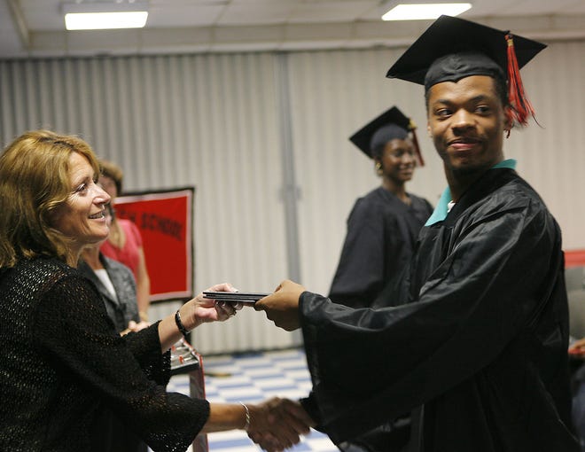 Summer Program Headmaster Catherine Leger presents a diploma to Gerard Divers in 2008