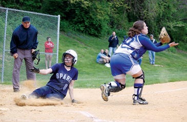 Photo by Kelly Hill/New Jersey Herald 
 
 Sparta’s Sam Casey slides safely into home while Kittatinny catcher Chelsea Falotico waits for the throw during the first inning Saturday at Memorial Field. The Spartans won, 2-1, to reach the HWS finals.