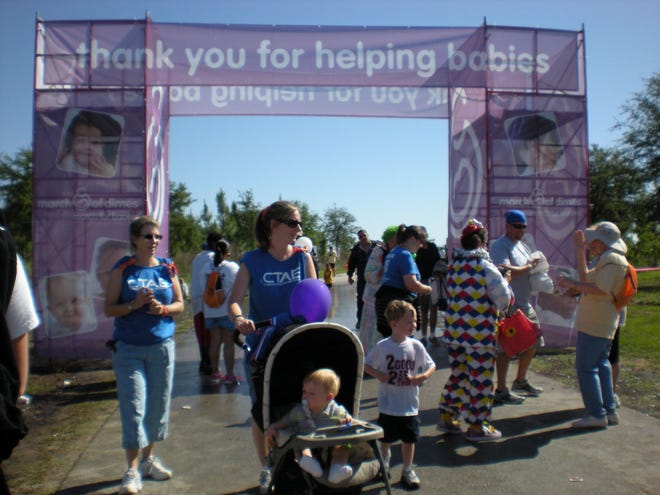Walkers cross the finish line at the 41st annual March for Babies in late April. The event raised $320,000 for March of Dimes. (Special to the Star-Banner)