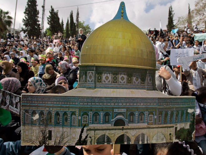 Palestinian children, one holding a Dome of the Rock cutout during a rally marking the 63rd anniversary of the Nakba, or catastrophe, the Arabic term used to describe the uprooting of hundreds of thousands of Palestinians with the 1948 creation of the state of Israel, in the West Bank City of Nablus, Sunday, May 15, 2011.(AP Photo/Nasser Ishtayeh)
