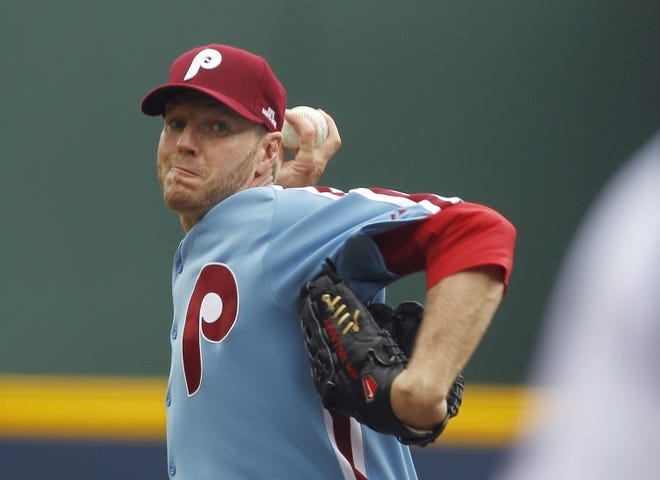 Phillies starting pitcher Roy Halladay throws to an Atlanta Braves batter in the first inning on Sunday.