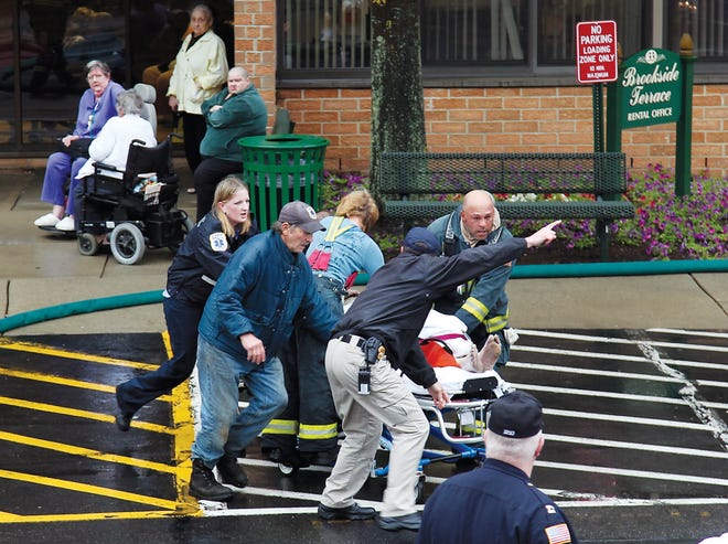Photo by Sara Hudock-Cole/New Jersey Herald
 
Fifth-floor resident John Heemer is rushed to a waiting ambulance during a blaze at Brookside Terrace in Newton Tuesday. Heemer was pronounced dead at Newton Medical Center.