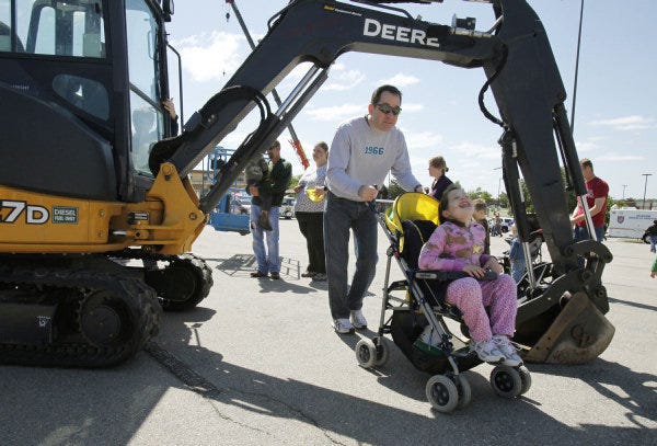 Children and their parents turned out to see numerous vehicles at an Edmond Touch-A-Truck event. The MOMS Club of Edmond East hosted the event and raised $5,100 for the Oklahoma Regional Food Bank's Food for Kids program. PHOTO BY PAUL HELLSTERN, THE OKLAHOMAN PAUL HELLSTERN