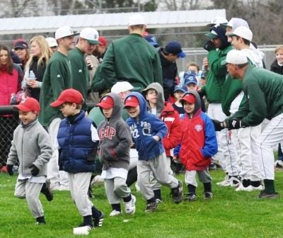 Pennridge High School baseball players greet Deep Run Little League teams as they are introduced during opening day ceremonies.