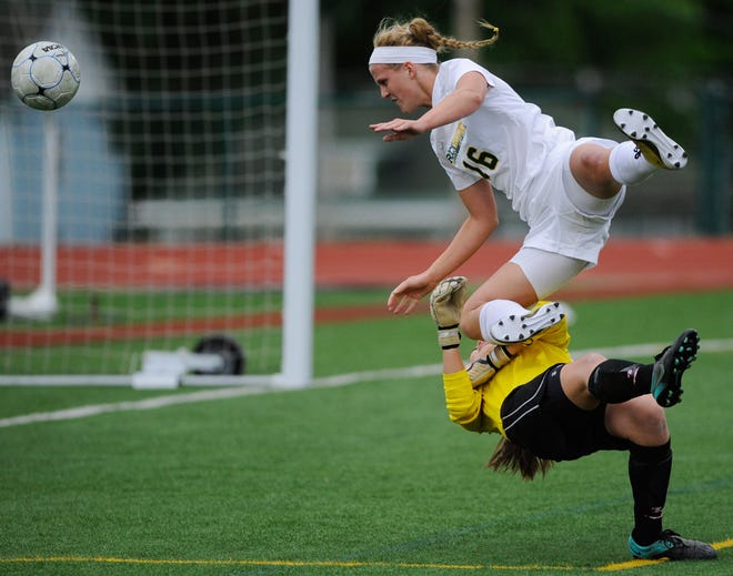 Rock Bridge’s Carmen Boessen crashes into Jefferson City goalie Ellen Weirich in the first half of the Bruins’ 3-0 victory in the Class 3 District 9 Tournament final Wednesday night on LeMone Field. Boessen scored two goals to help the Bruins win the district title for the third straight year.