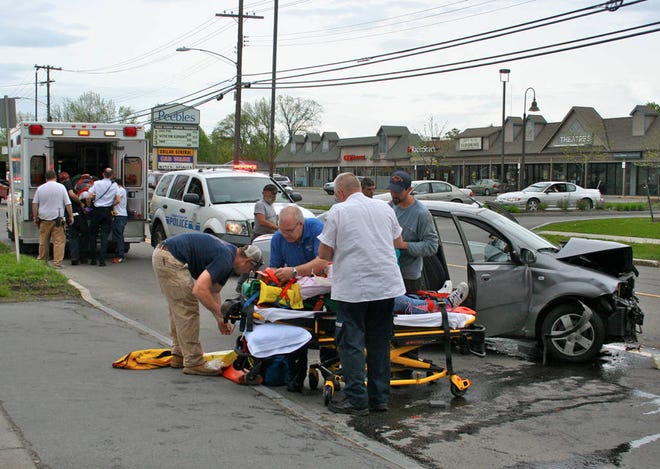 Penn Yan Ambulance volunteers load Cindy Sanderson into an ambulance in the background while others prepare Jolene Sanderson to be taken to Soldiers & Sailors Memorial Hospital following a Wednesday afternoon accident on Lake Street. Both were treated and released.