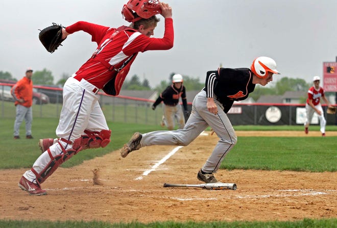 Oregon's Tyler Bowers (9) chases down a bunt by Byron's Jenner Eisele (2) in the third inning Wednesday, May 18, 2011, during their game in the IHSA Baseball Regional at Stillman Valley. Eisele brought in two runs on the play and made it to third.