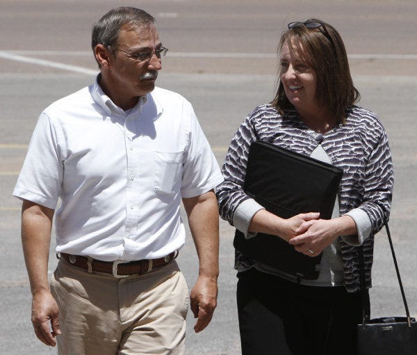 Bobbi Parker talks with her husband, Randy Parker, as they walk back to the courthouse in Mangum during a break in jury selection for her trial. Bobbi Parker is accused of helping a convicted killer escape and running away with him. (AP Photo/Sue Ogrocki) ORG XMIT: OKSO105 Sue Ogrocki - AP