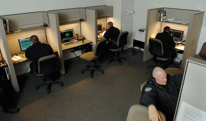 Columbia Police officers share a room where 11 report-writing stations are located. A consultant is studying whether the department needs to build one or more precinct facilities.