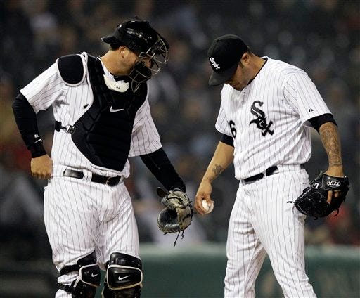 Chicago White Sox relief pitcher Sergio Santos, right, looks down as he listens to catcher A.J. Pierzynski after Los Angeles Dodgers' Matt Kemp's single during the 10th inning of an interleague baseball game in Chicago, Friday, May 20, 2011. The Dodgers won 6-4.