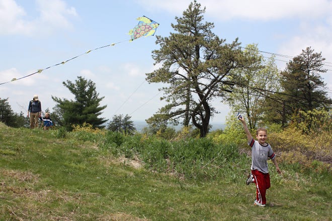 Ryan Cochrane, 6, of Braintree, works hard to have his kite take flight during a mild weather day at the Blue Hills Observatory on Sat., May 21, 2011.