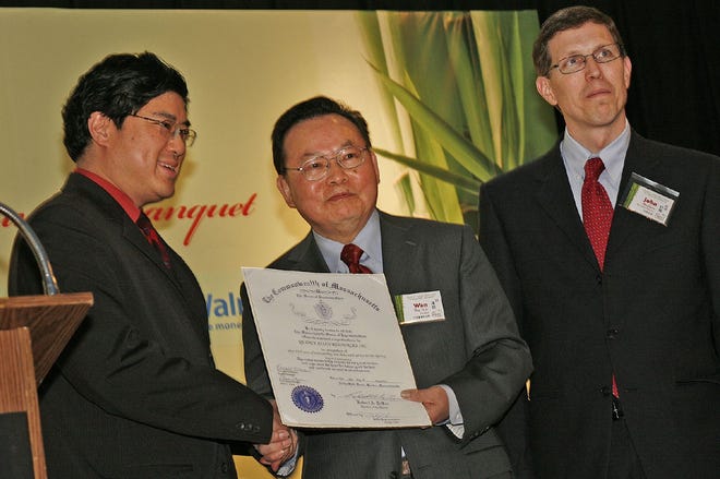 Quincy Asian Resources holds a 10-year anniversary banquet at the China Pearl Restaurant in Quincy on Friday May 20, 2011. Massachusetts Representative Tackey Chan of Quincy, left, presents Dr. Wan Wu and John Brothers of QARI with a commendation for 10 years of work in Quincy.