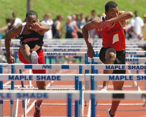 Willingboro's Isaac Williams (left) leads Cherokee's Darren McCluskey in the 100-meter hurdles. Williams hung on to win by .04 of a second, one of his three first-place finishes.