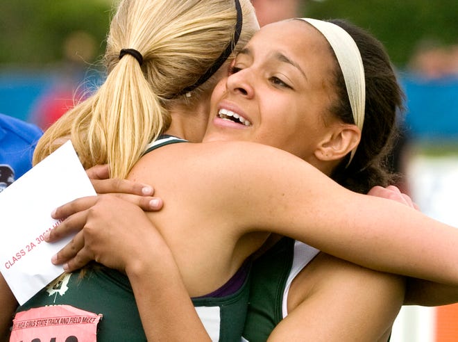 Richwoods sophomore Brenna Detra hugs Kaci Storm of Geneseo after winning the Class 2A 300 meter low hurdles at the girl's track and field state finals on Saturday held at Eastern Illinois University in Charleston. Detra won the race with a time of 43.10, and also placed in long jump, 200 meter run and 100 meter low hurdles.