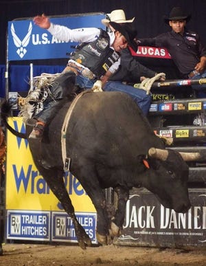 Bull rider Robson Palermo hangs on to a bull named ‘My Space’ for a score of 88 points to qualify for the final round during the U.S. Air Force Invitational at the Colorado State Fair Events Center.