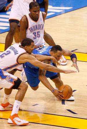 Oklahoma City's Thabo Sefolosha (2) and Kevin Durant (35) defend Shawn Marion (0) of Dallas during game 4 of the Western Conference Finals in the NBA basketball playoffs between the Dallas Mavericks and the Oklahoma City Thunder at the Oklahoma City Arena in downtown Oklahoma City, Monday, May 23, 2011. Photo by Bryan Terry, The Oklahoman