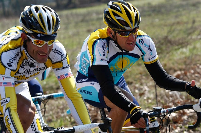 Lance Armstrong, right, pedals during an 1999 race. The Associated Press